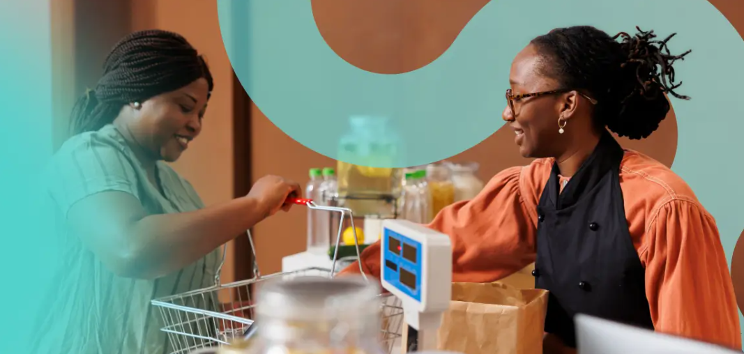 Two women at a community grocery counter